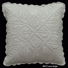 a white pillow that is made with crochet and thread on the front side