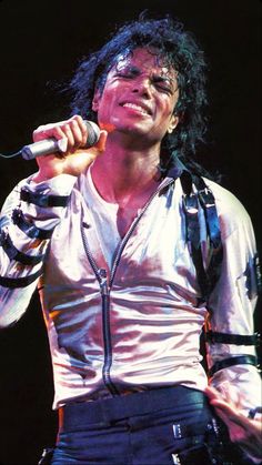 michael jackson performing on stage with microphone in his hand