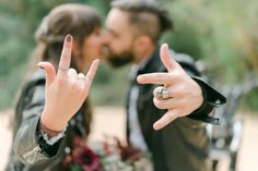 a man and woman making the peace sign with their fingers