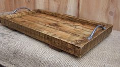 a wooden tray sitting on top of a cushion