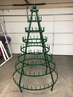 a green metal christmas tree in a garage