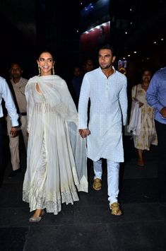 ranve and deepika are seen walking hand in hand through the crowd at an event