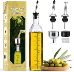 the olive oil bottle set is next to some olives and a measuring cup with an olive in it