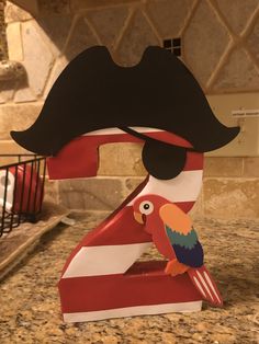 a pirate number with a parrot sitting on it's head in front of a kitchen counter