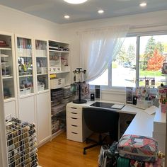 a home office with lots of clutter on the desk and shelves full of books