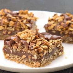 three pieces of chocolate peanut butter granola bars on a white plate