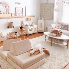 a living room filled with lots of furniture and decor on top of a white rug