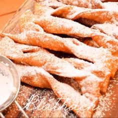 powdered sugar covered pastries on a tray