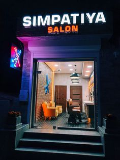 the entrance to simpatiya salon with bright lights on it's windows and stairs