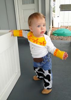 a toddler standing in front of a white door