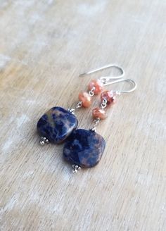 Sodalite Earrings Sterling Silver, Blue and Orange Earrings, Carnelian Earrings, Square Shaped Gemstone Dangle Earrings, Sunset Sodalite Dark indigo blue and orange sunset sodalite gemstones displaying lovely patterns dangle from mystic coated carnelian gemstones and sterling silver ear wires. The total length of the earrings is approximately 2 inches. The square orange sodalite gemstones are about 1/2 inch wide and 1/2 inch tall. They are faceted and polished on both sides. The blue and orange Agate Gemstone Dangle Earrings, Agate Gemstone Bead Dangle Earrings, Agate Gemstone Drop Earrings, Agate Dangle Earrings With Ear Wire, Natural Stone Agate Dangle Earrings, Agate Natural Stone Dangle Earrings, Agate Dangle Earrings With Natural Stones, Dangle Earrings With Natural Agate Stones, Lapis Lazuli Natural Stones Drop Earrings