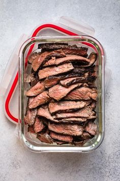 a glass container filled with meat sitting on top of a counter