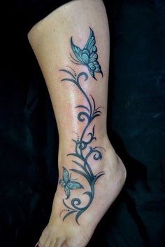 a woman's foot with a butterfly tattoo on it