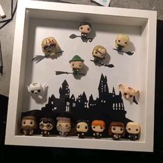 a shadow box filled with lots of different halloween characters in front of a white frame