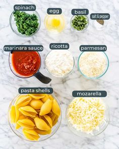 the ingredients to make this pasta recipe are shown in bowls on a marble countertop