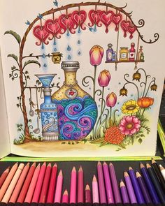 colored pencils next to a drawing of a vase and flowers