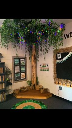 a tree with lights on it in the middle of a room