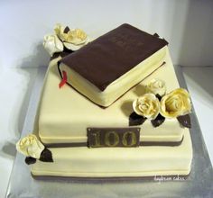 a cake decorated with books and flowers