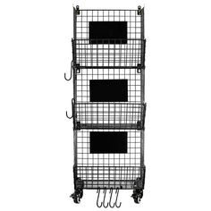 three metal baskets are stacked on top of each other, with hooks hanging from them