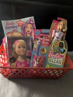 a basket filled with barbie dolls and other toys