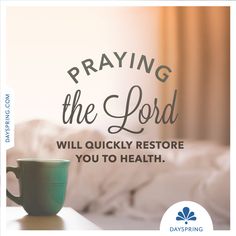 a coffee cup sitting on top of a table next to a window with the words praying the lord will quickly restore you to health