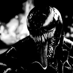 an alien man in black and white with his mouth open