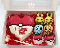 an open box with some pokemon themed treats in it's lid and the words i love you written on them