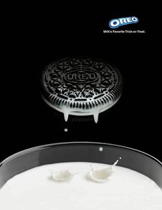 an oreo cookie on top of a pan with milk coming out of the bottom