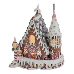 a gingerbread house with lights and candy on the roof is shown in front of a white background