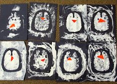 four penguins painted on black and white paper with orange eyes, one penguin has an orange nose