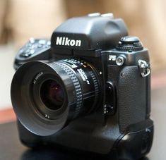 a black camera sitting on top of a table