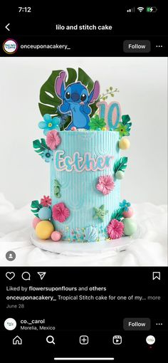 an image of a birthday cake with lilo and stitch on the top, surrounded by flowers