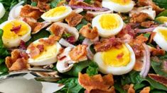 a salad with hard boiled eggs and bacon