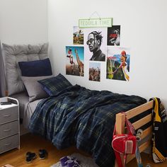 a bedroom with pictures on the wall and a bed in front of it, along with other items