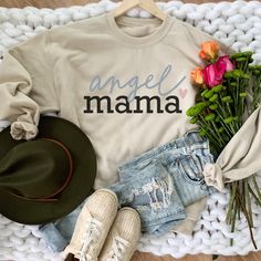 Angel Mama Heart Sweatshirt. HOW TO ORDER T-SHIRT 1- Please, Check and Review all Photos. 2- Choose your size from the drop-down menu 3- Select Your Shirt Color from Drop-down 2 4- Repeat for each shirt ordered 8 oz.(US) 13.5 oz.(CA), 50/50 preshrunk cotton/polyester Heather colors- 90/10 airlume combed and ringspun cotton/polyester Deep Heather Grey- 3.6 oz., 65% Polyester/35% Ring-Spun cotton Double-lined hood with color-matched drawcord Double needle stitching at shoulder, armhole, neck, wais Crew Neck Cotton Hoodie For Mother's Day, Crew Neck Cotton Hoodie, Long Sleeve Hoodie With Letter Print For Mother's Day, Mother's Day Cotton Sweatshirt With Letter Print, Cotton Hoodie Top With Lettering, White Crew Neck Hoodie For Mother's Day, White Cotton Hoodie For Mother's Day, Angel Mama, Angel Mom