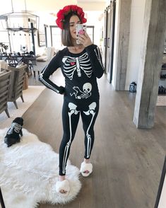 a woman in skeleton costume taking a selfie