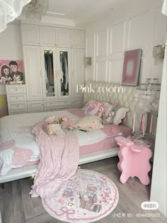 a bedroom with pink decor and white furniture