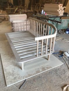 a metal bed frame sitting on top of a hard wood floor in a room filled with construction materials