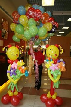 some balloons are in the shape of people holding flowers