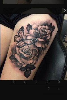 a woman's thigh with roses and butterflies on it