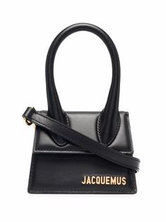 Black calf leather Le Chiquito mini tote bag from JACQUEMUS featuring gold-tone logo plaque, single top handle, foldover top with magnetic fastening, main compartment and adjustable detachable shoulder strap. | Jacquemus Le Chiquito mini tote bag Jacquemus Le Chiquito, Tas Mini, Basket Sport, Jacquemus Bag, Mini Accessories, Black Leather Tote Bag, Mini Tote Bag, Dolce E Gabbana, Bag Trends