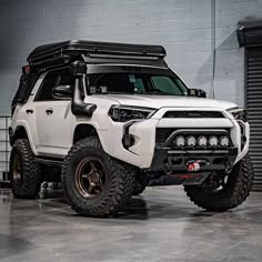 a white toyota truck parked in a garage