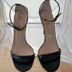 Never Worn Gucci Black Latex Heels In Size 37.5 Comes With Dust Bag And Box No Counter Offers Will Be Accepted And No Trades. 100% Authentic Designer Heels With Ankle Strap And Padded Heel, Designer Heels With Padded Heel And Ankle Strap, Gucci Black Formal Sandals, Chic Gucci Block Heel Heels, Designer Block Heels With Wrapped Heel, Formal Black Gucci Sandals, Gucci Luxury Block Heel Heels, Gucci Luxury Block Heel Shoes, Elegant Gucci Pointed Toe Sandals