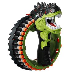 a green and black toy with an alligator on it's back