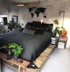 a bed room with a neatly made bed and lots of plants on the side table