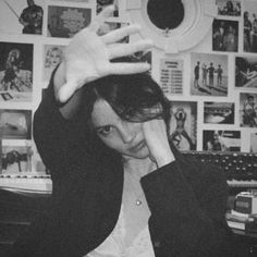 black and white photograph of a woman holding her hand up in front of her face