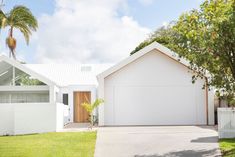 an image of a white house with palm trees in the front yard and text that reads sunshine coast - sunshine coast, queensland