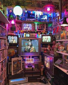 a room filled with lots of different types of televisions and video game equipment in it