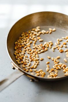 peanuts are being cooked in a frying pan