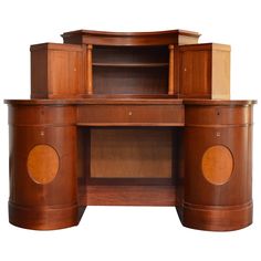 an old fashioned wooden desk with two cupboards on one side and a bookcase on the other